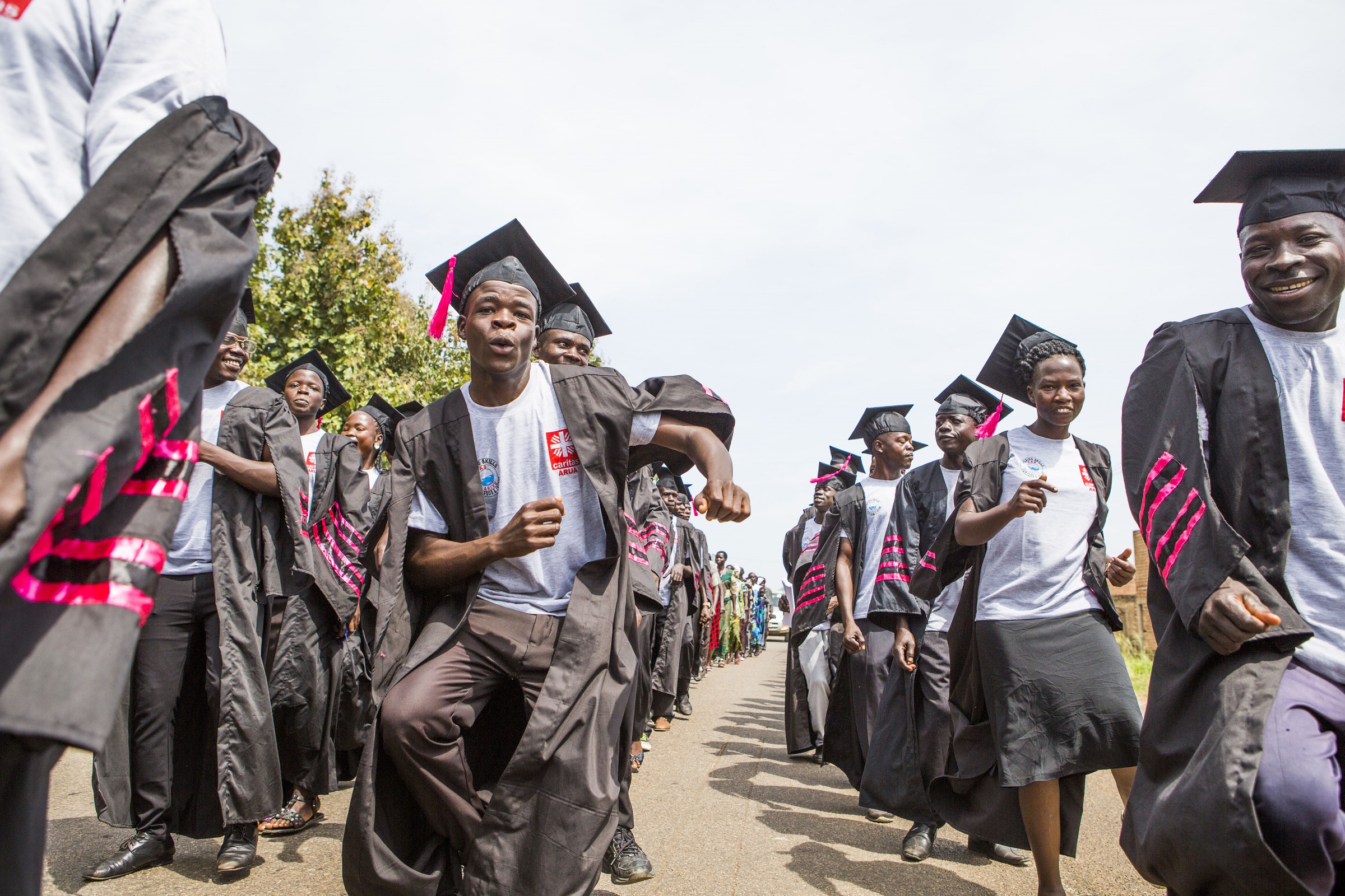 Glade studenter i Uganda feirer at de har gjennomført yrkesutdanning i fiskeoppdrett