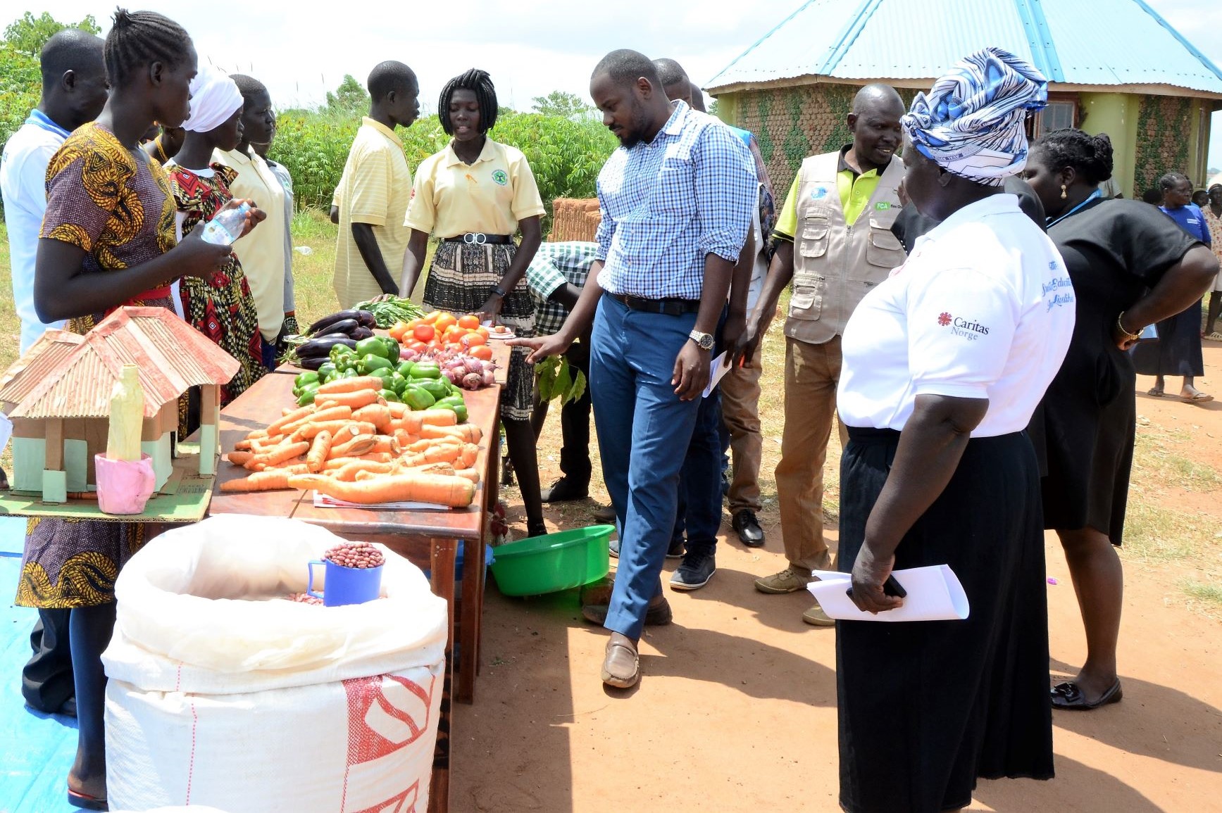 Egendyrkede grønnsaker vises frem for ledelsen i Bidibidi og Caritas Uganda i forbindelse med uteksamineringen.